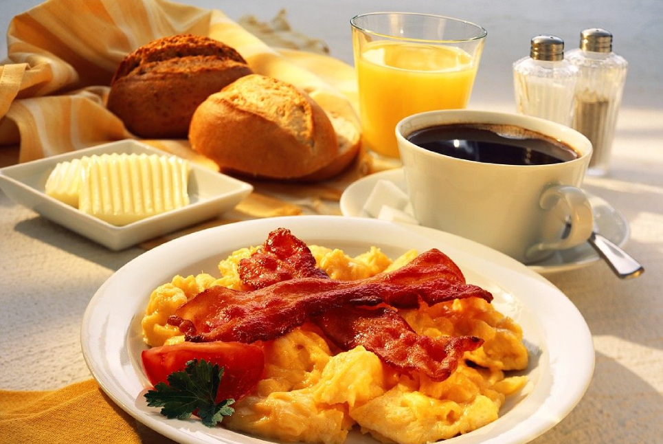 breakfast-with-scrambled-eggs-and-bacon-coffee-orange-juice-and-rolls